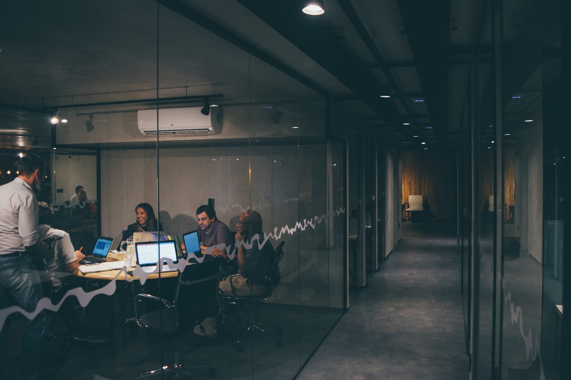 People collaborating in an office — shared knowledge, every team member.